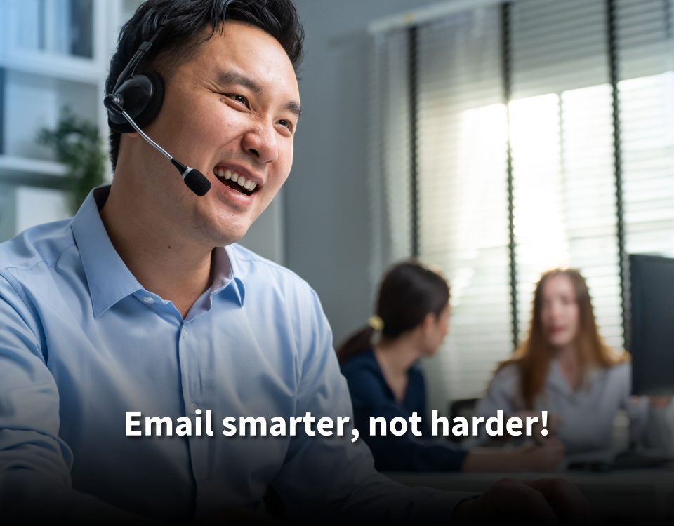 A smiling male customer service agent wearing a headset in a bright office, with colleagues working in the background. Text reads: 'Email smarter, not harder!