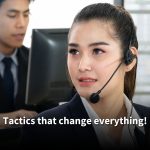 A female call center agent in a suit and headset looks focused while working on her computer. Text reads: 'Tactics that change everything!