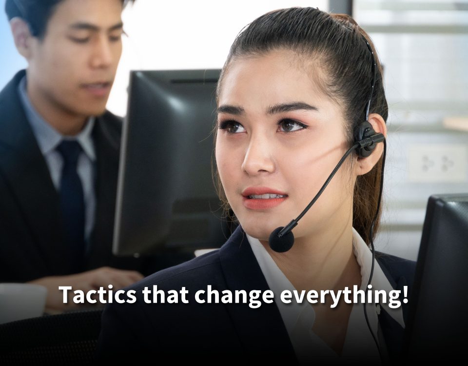 A female call center agent in a suit and headset looks focused while working on her computer. Text reads: 'Tactics that change everything!