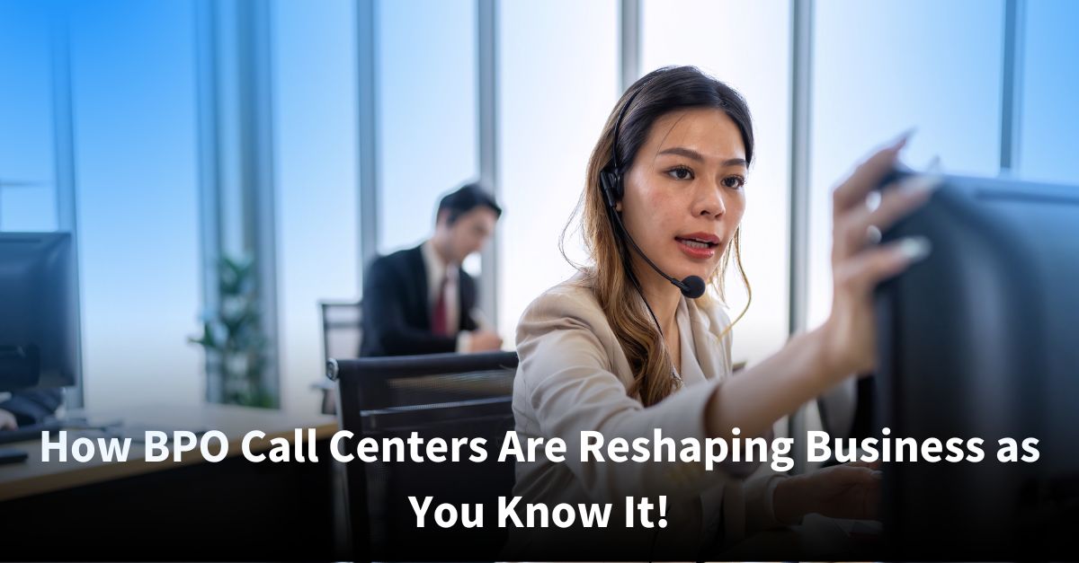 A female call center agent wearing a headset focuses on her computer screen as she assists a caller, while a colleague works in the background of a bright, modern office.