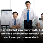 A team of confident professionals in a modern office setting, standing and seated around a whiteboard with strategic diagrams. The image represents the benefits of outsourcing integral services to accelerate business growth and streamline operations.