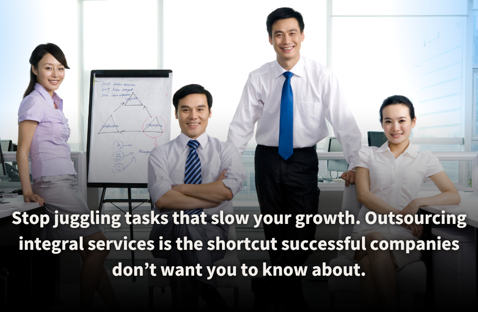 A team of confident professionals in a modern office setting, standing and seated around a whiteboard with strategic diagrams. The image represents the benefits of outsourcing integral services to accelerate business growth and streamline operations.