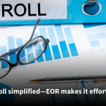 A close-up of financial documents with graphs and charts, a pair of eyeglasses, and a pen placed on top, with a blue binder labeled 'PAYROLL' in the background. Text overlay reads: 'Payroll simplified—EOR makes it effortless!'